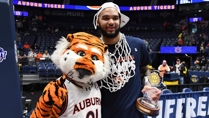 Mar 17, 2024; Nashville, TN, USA; Auburn Tigers forward Johni Broome (4) celebrates with Aubie the