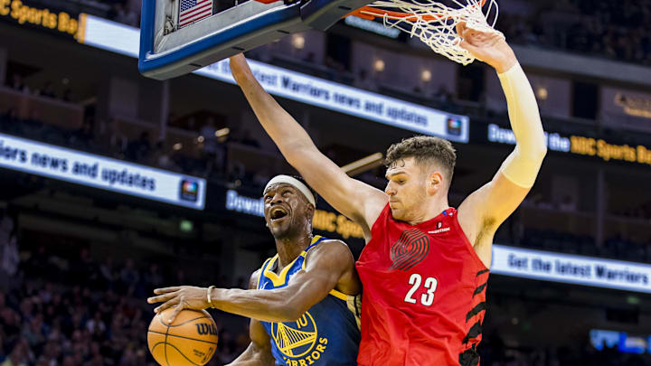 Mar 10, 2025; San Francisco, California, USA; Golden State Warriors forward Jimmy Butler III (10) is fouled by Portland Trail Blazers center Donovan Clingan (23) during the second quarter at Chase Center. Mandatory Credit: John Hefti-Imagn Images