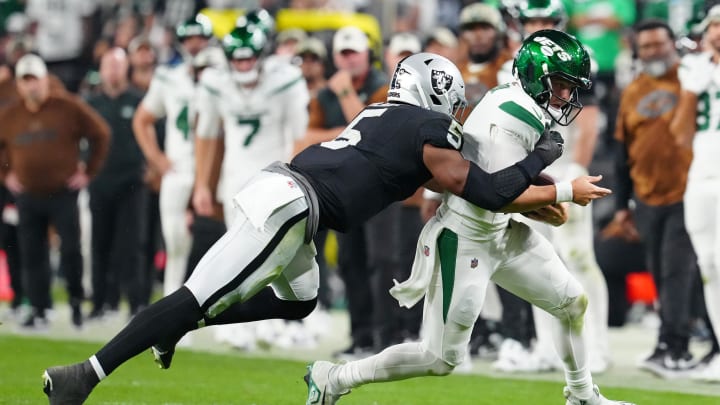 Nov 12, 2023; Paradise, Nevada, USA; New York Jets quarterback Zach Wilson (2) is tackled by Las Vegas Raiders linebacker Divine Deablo (5) during the fourth quarter at Allegiant Stadium. Mandatory Credit: Stephen R. Sylvanie-USA TODAY Sports