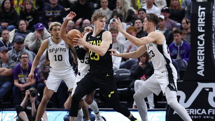 Mar 27, 2024; Salt Lake City, Utah, USA; Utah Jazz forward Lauri Markkanen (23) goes to the basket against San Antonio Spurs forward Jeremy Sochan (10), guard Tre Jones (33) and forward Zach Collins (23) during the fourth quarter during the fourth quarter at Delta Center. Mandatory Credit: Rob Gray-USA TODAY Sports