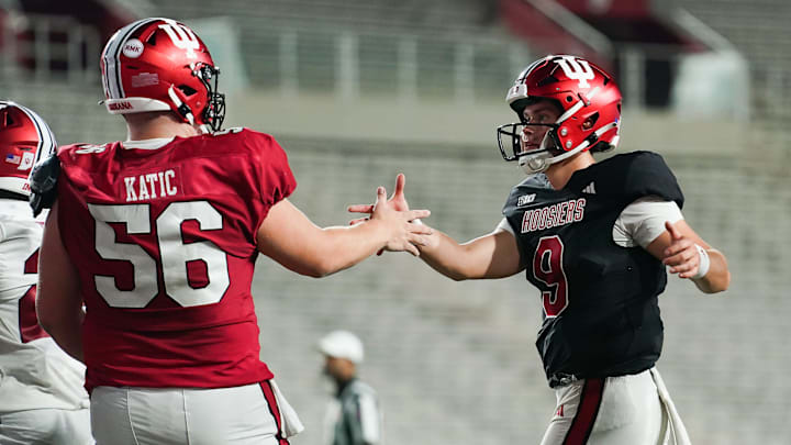 Indiana Hoosiers offensive lineman Mike Katic (56) celebrates with Indiana Hoosiers quarterback Kurtis Rourke (9) after a touchdown during the Indiana football spring game at Memorial Stadium on Thursday, April 18, 2024.