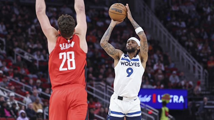 Feb 21, 2025; Houston, Texas, USA; Minnesota Timberwolves guard Nickeil Alexander-Walker (9) shoots the ball as Houston Rockets center Alperen Sengun (28) defends during the first quarter at Toyota Center. Mandatory Credit: Troy Taormina-Imagn Images