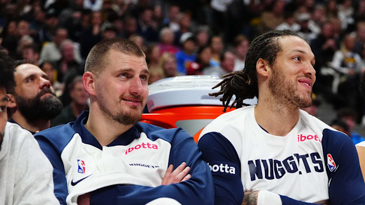 Dec 23, 2024; Denver, Colorado, USA; Denver Nuggets center Nikola Jokic (15) and forward Aaron Gordon (32) and forward Michael Porter Jr. (1) on the bench in the fourth quarter against the Phoenix Suns at Ball Arena. Mandatory Credit: Ron Chenoy-Imagn Images