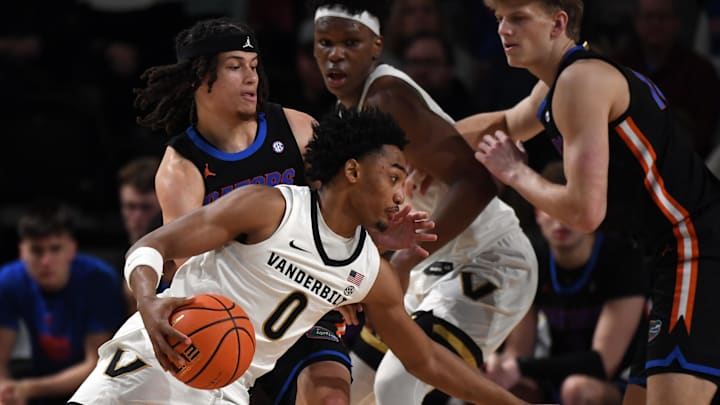 Mar 9, 2024; Nashville, Tennessee, USA; Vanderbilt Commodores guard Tyrin Lawrence (0) drives to the basket against Florida Gators guard Walter Clayton Jr. (1) during the first half at Memorial Gymnasium. Mandatory Credit: Christopher Hanewinckel-Imagn Images