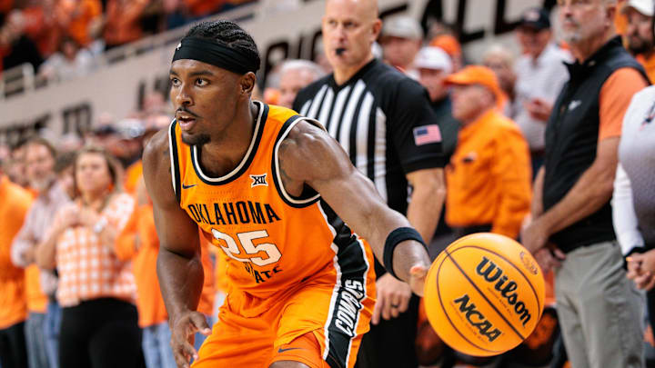 Nov 9, 2025; Stillwater, Oklahoma, USA; Oklahoma State Cowboys forward Robert Jennings (25) passes the ball during the first half against the Texas A&M Aggies at Gallagher-Iba Arena. Mandatory Credit: William Purnell-Imagn Images
