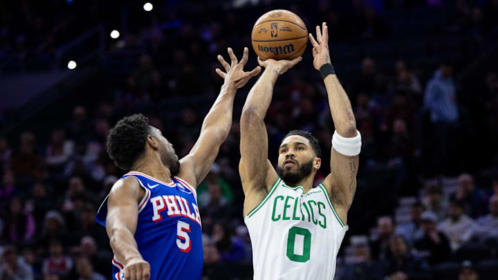 Boston Celtics forward Jayson Tatum shoots past Philadelphia 76ers guard Quentin Grimes.