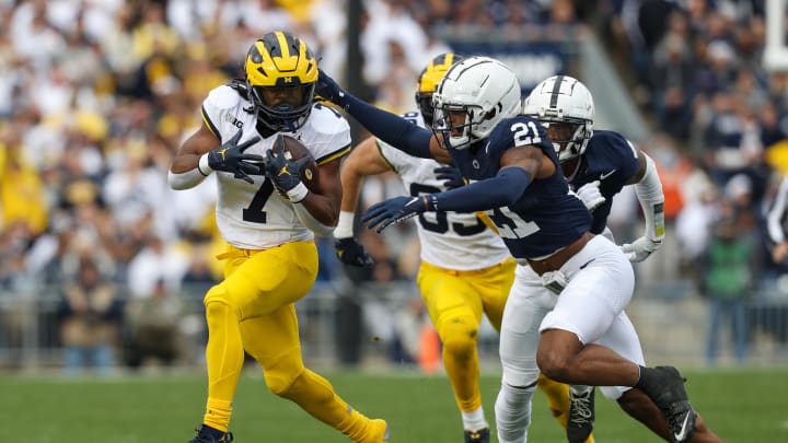 Nov 11, 2023; University Park, Pennsylvania, USA; Michigan Wolverines running back Donovan Edwards (7) runs the ball against Penn State Nittany Lions Kevin Winston Jr. (21) during the second quarter at Beaver Stadium. Michigan won 24-15. Mandatory Credit: Matthew O'Haren-USA TODAY Sports