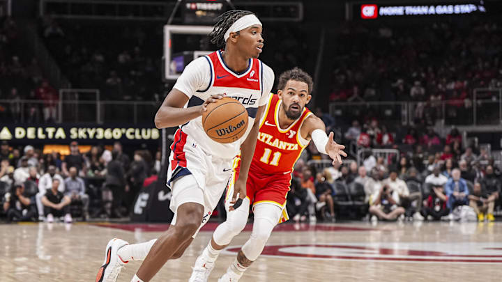 Oct 28, 2024; Atlanta, Georgia, USA; Washington Wizards guard Bilal Coulibaly (0) dribbles past Atlanta Hawks guard Trae Young (11) during the first half at State Farm Arena. Mandatory Credit: Dale Zanine-Imagn Images