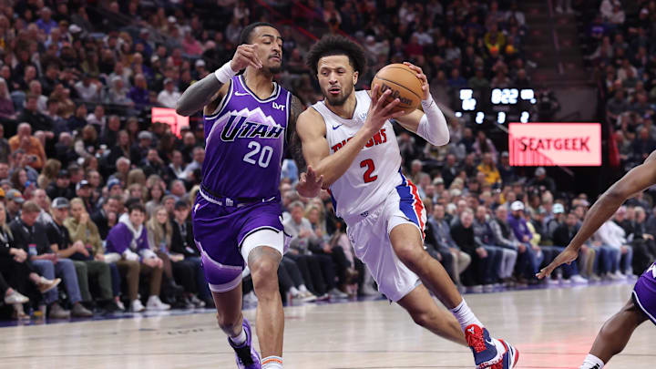 Jan 3, 2024; Salt Lake City, Utah, USA; Detroit Pistons guard Cade Cunningham (2) drives to the basket defended by Utah Jazz forward John Collins (20) during the third quarter at Delta Center. Mandatory Credit: Rob Gray-Imagn Images