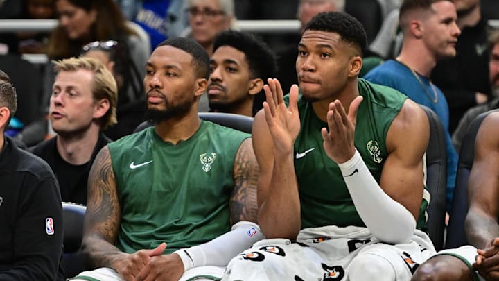Oct 20, 2023; Milwaukee, Wisconsin, USA; Milwaukee Bucks forward Giannis Antetokounmpo (34) and guard Damian Lillard (0) watch game against the Memphis Grizzlies in the second quarter at Fiserv Forum. Mandatory Credit: Benny Sieu-Imagn Images