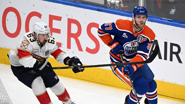 Connor McDavid skates past Brad Marchand during the Stanley Cup Final.