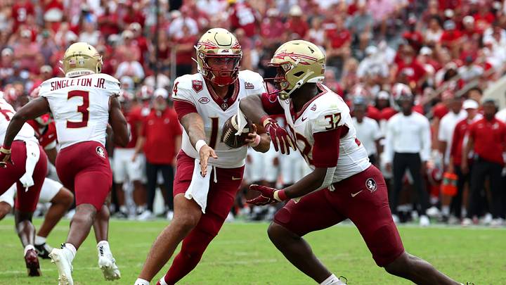 Sep 19, 2026; Tuscaloosa, Alabama, USA; Florida State Seminoles quarterback Ashton Daniels (14) fakes a handoff to Florida State Seminoles running back Ousmane Kromah (32) during the first quarter against the Alabama Crimson Tide at Saban Field at Bryant-Denny Stadium. Mandatory Credit: David Leong-Imagn Images Sep 19, 2026; Tuscaloosa, Alabama, USA; Florida State Seminoles quarterback Ashton Daniels (14) fakes a handoff to Florida State Seminoles running back Ousmane Kromah (32) during the first quarter against the Alabama Crimson Tide at Saban Field at Bryant-Denny Stadium. Mandatory Credit: David Leong-Imagn Images
