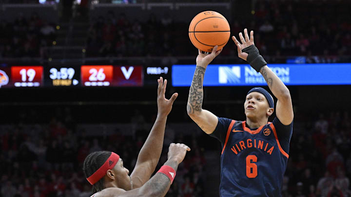 Jan 13, 2026; Louisville, Kentucky, USA;  Virginia Cavaliers guard Jacari White (6) shoots against Louisville Cardinals guard Ryan Conwell (3) during the first half at KFC Yum! Center. Mandatory Credit: Jamie Rhodes-Imagn Images