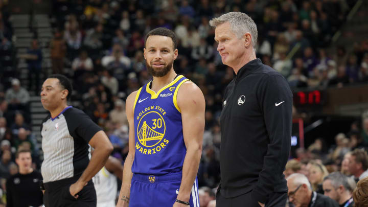 Feb 15, 2024; Salt Lake City, Utah, USA; Golden State Warriors guard Stephen Curry (30) and head coach Steve Kerr talk on the sideline during the first quarter against the Utah Jazz at Delta Center. Mandatory Credit: Chris Nicoll-USA TODAY Sports