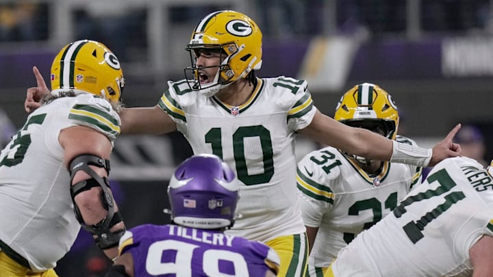 Green Bay Packers quarterback Jordan Love (10) makes an adjustment at the line against the Minnesota Vikings.