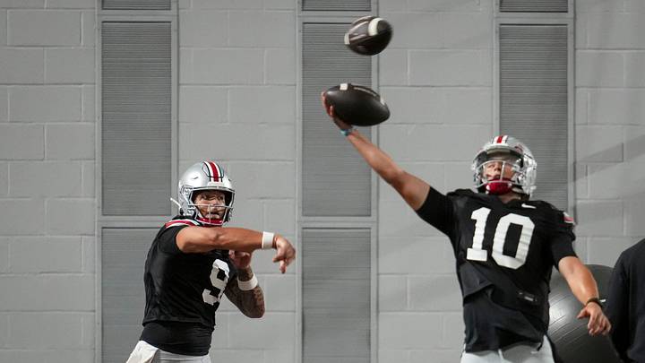 Ohio State Buckeyes quarterback Tavien St. Clair (9) passes behind quarterback Julian Sayin (10) during football training camp inside the Woody Hayes Athletic Center in Columbus on Aug. 7, 2026.