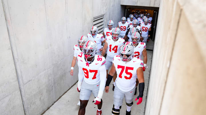 Ohio State Buckeyes defensive end Kenyatta Jackson Jr. (97) and Carson Hinzman (75) take the field with their teammates before the game against the Wisconsin Badgers at Camp Randall Stadium on Saturday, Oct. 18, 2025 in Madison, Wisconsin.
