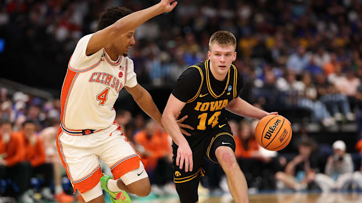 Mar 20, 2026; Tampa, FL, USA; Iowa Hawkeyes guard Bennett Stirtz (14) drives the ball while defended by Clemson Tigers guard Butta Johnson (4) in the second half during a first round game of the men's 2026 NCAA Tournament at Benchmark International Arena. Mandatory Credit: Matt Pendleton-Imagn Images
