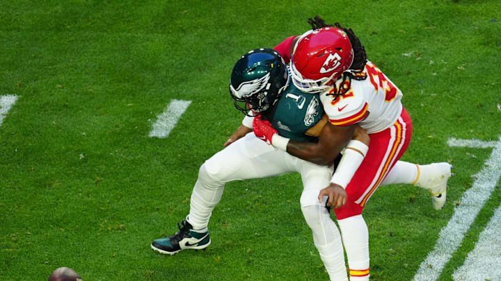 Philadelphia Eagles quarterback Jalen Hurts (1) fumbles the ball against Kansas City Chiefs linebacker Nick Bolton (32) during the first half in Super Bowl LVII at State Farm Stadium in Glendale on Feb. 12, 2023.