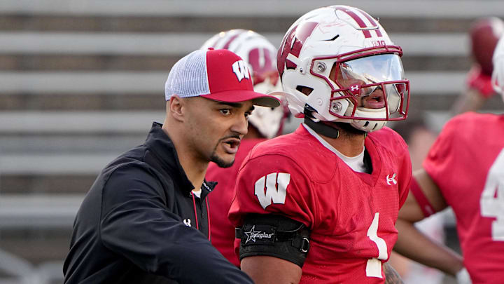 Apr 11, 2023; Madison, WI, USA; Wisconsin running backs coach Devon Spalding talks with running back Chez Mellusi (1) during practice Tuesday, April 11, 2023 at Camp Randall Stadium in Madison, Wis. Apr 11, 2023; Madison, WI, USA; Wisconsin running backs coach Devon Spalding talks with running back Chez Mellusi (1) during practice Tuesday, April 11, 2023 at Camp Randall Stadium in Madison, Wis.