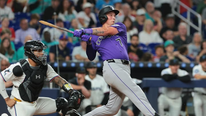 Colorado Rockies first baseman TJ Rumfield (7) hits a single against the Miami Marlins during the ninth inning at loanDepot Park.