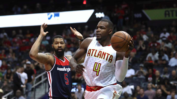 Apr 28, 2017; Atlanta, GA, USA; Atlanta Hawks forward Paul Millsap (4) passes away from the defense of Washington Wizards forward Markieff Morris (5) in the third quarter of game six of the first round of the 2017 NBA Playoffs at Philips Arena. Mandatory Credit: Jason Getz-Imagn Images