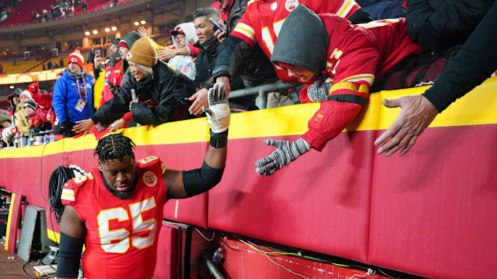 Jan 18, 2025; Kansas City, Missouri, USA; Kansas City Chiefs guard Trey Smith (65) greets fans while leaving the field after a 2025 AFC divisional round game against the Houston Texans at GEHA Field at Arrowhead Stadium. Mandatory Credit: Denny Medley-Imagn Images