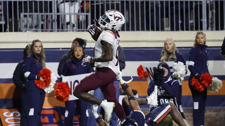 Nov 25, 2023; Charlottesville, Virginia, USA; Virginia Tech Hokies wide receiver Da'Quan Felton (9) runs with the ball en route to a touchdown as Virginia Cavaliers safety Jonas Sanker (20) attempts the tackle during the third quarter at Scott Stadium. Mandatory Credit: Geoff Burke-USA TODAY Sports