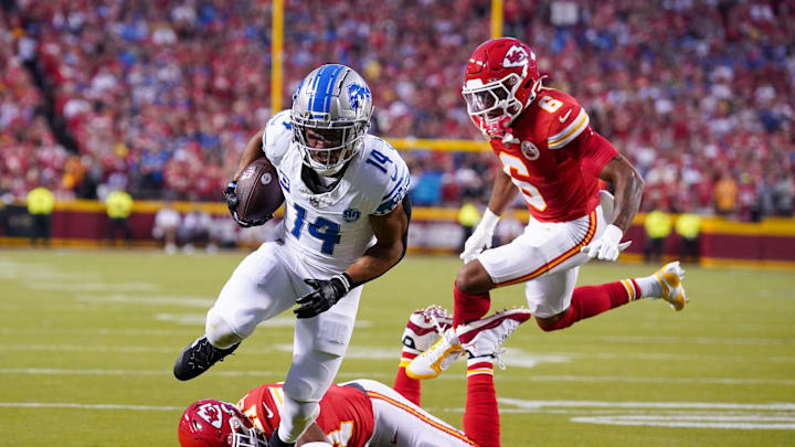 Sep 7, 2023; Kansas City, Missouri, USA; Detroit Lions wide receiver Amon-Ra St. Brown (14) scores a touchdown as Kansas City Chiefs safety Mike Edwards (21) and safety Bryan Cook (6) miss the tackle during the first half at GEHA Field at Arrowhead Stadium. Mandatory Credit: Denny Medley-Imagn Images