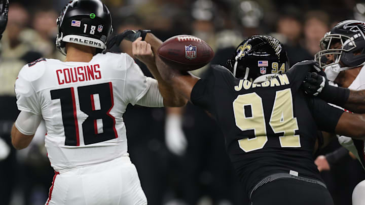 Nov 23, 2025; New Orleans, Louisiana, USA; Atlanta Falcons quarterback Kirk Cousins (18) is stripped of the ball by. New Orleans Saints defensive end Cameron Jordan (94) during the first half at Caesars Superdome. Mandatory Credit: Stephen Lew-Imagn Images