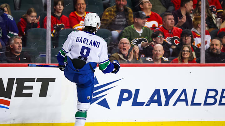 Mar 12, 2025; Calgary, Alberta, CAN; Vancouver Canucks right wing Conor Garland (8) celebrates his goal against the Calgary Flames during the shootout period at Scotiabank Saddledome. Mandatory Credit: Sergei Belski-Imagn Images
