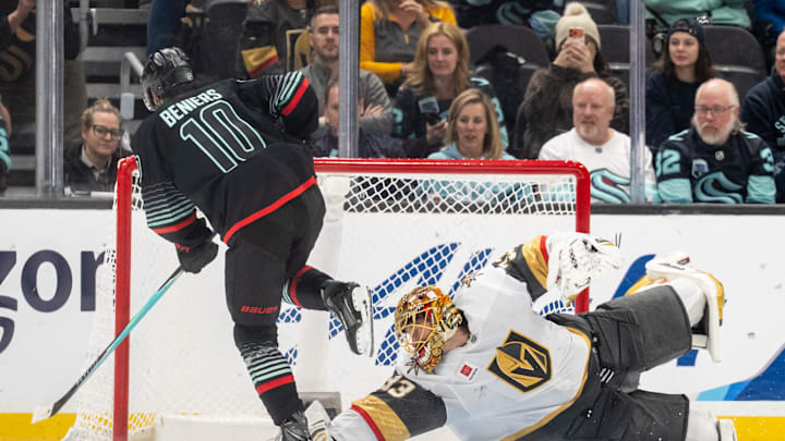 Apr 9, 2026; Seattle, Washington, USA;  Seattle Kraken forward Matty Beniers (10) hops over Vegas Golden Knights goalie Adin Hill (33) after scoring during a shootout at Climate Pledge Arena. Mandatory Credit: Stephen Brashear-Imagn Images