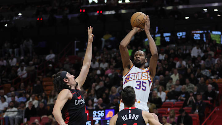 Jan 29, 2024; Miami, Florida, USA; Phoenix Suns forward Kevin Durant (35) shoots the basketball over Miami Heat guard Jaime Jaquez Jr. (11) and guard Tyler Herro (14) during the second quarter at Kaseya Center. Mandatory Credit: Sam Navarro-Imagn Images