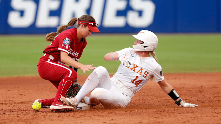 Texas' Reese Atwood (14) steals second as Oklahoma infielder Avery Hodge (82) drops the ball in the second inning of Game 2 of the NCAA softball Women's College World Series Championship Series game between the Oklahoma Sooners (OU) and Texas Longhorns at Devon Park in Oklahoma City, Thursday, June, 6, 2024. Texas' Reese Atwood (14) steals second as Oklahoma infielder Avery Hodge (82) drops the ball in the second inning of Game 2 of the NCAA softball Women's College World Series Championship Series game between the Oklahoma Sooners (OU) and Texas Longhorns at Devon Park in Oklahoma City, Thursday, June, 6, 2024.