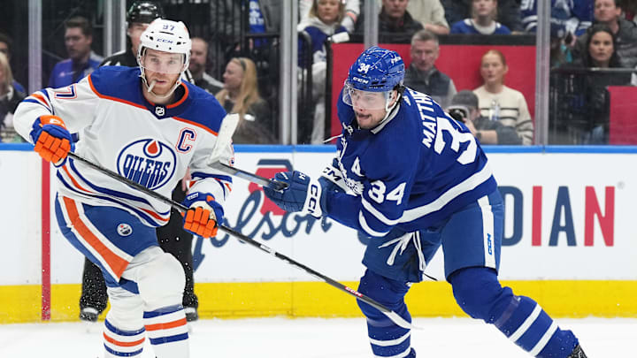Mar 11, 2023; Toronto, Ontario, CAN; Toronto Maple Leafs center Auston Matthews (34) battles with Connor McDavid (97) of the Edmonton Oilers.