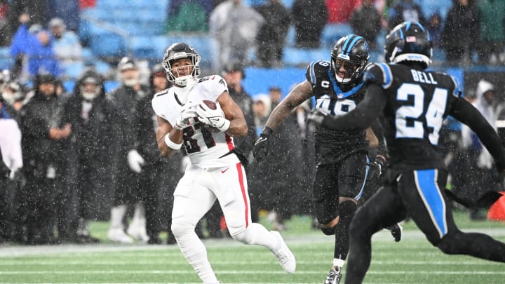 Dec 17, 2023; Charlotte, North Carolina, USA; Atlanta Falcons tight end Jonnu Smith (81) catches the ball as Carolina Panthers linebacker Frankie Luvu (49) and safety Vonn Bell (24) defend in the second quarter at Bank of America Stadium. 