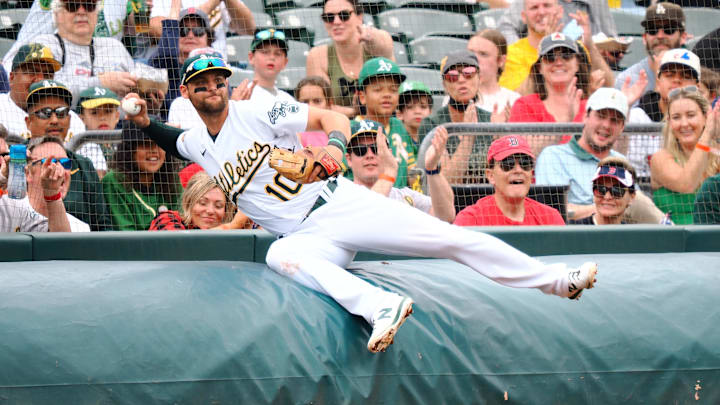 Jun 4, 2022; Oakland, California, USA; Oakland Athletics third baseman Chad Pinder (10) throws the ball after leaning over the tarp for a foul ball against the Boston Red Sox during the fourth inning at RingCentral Coliseum. Mandatory Credit: Kelley L Cox-Imagn Images