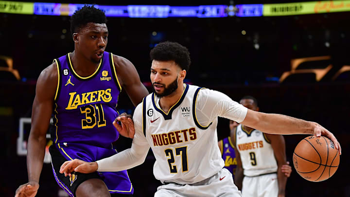 Dec 16, 2022; Los Angeles, California, USA; Denver Nuggets guard Jamal Murray (27) controls the ball against Los Angeles Lakers center Thomas Bryant (31)  during the first half at Crypto.com Arena. Mandatory Credit: Gary A. Vasquez-Imagn Images