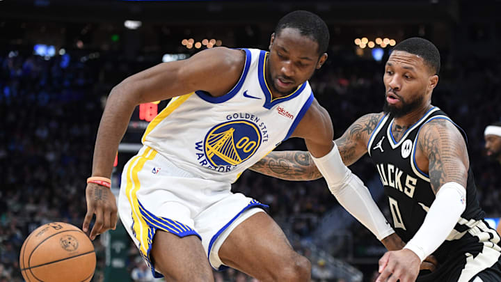 Jan 13, 2024; Milwaukee, Wisconsin, USA; Golden State Warriors forward Jonathan Kuminga (00) drives against Milwaukee Bucks guard Damian Lillard (0) in the first half at Fiserv Forum. Mandatory Credit: Michael McLoone-Imagn Images Jan 13, 2024; Milwaukee, Wisconsin, USA; Golden State Warriors forward Jonathan Kuminga (00) drives against Milwaukee Bucks guard Damian Lillard (0) in the first half at Fiserv Forum. Mandatory Credit: Michael McLoone-Imagn Images