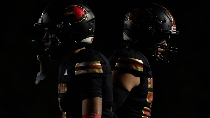 Ravenwood’s Donovan Starr walks by Colton Karkau while walking onto the field during the game against Brentwood at Ravenwood High School football stadium in Brentwood, Tenn., Friday, Nov. 1, 2024.