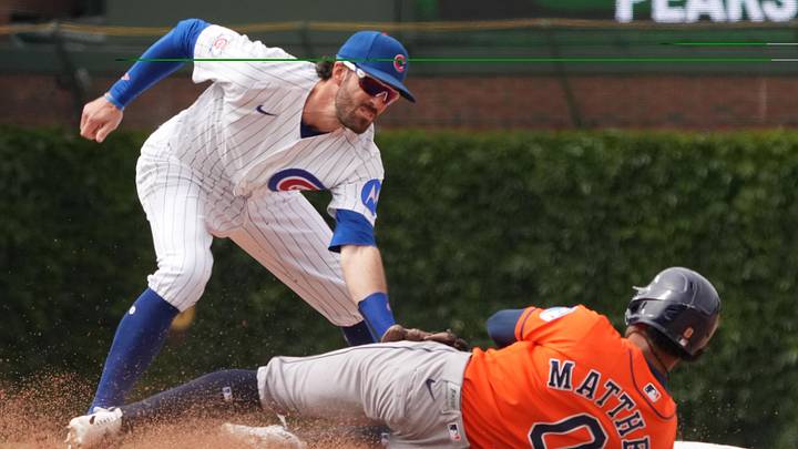 May 23, 2026; Chicago, Illinois, USA; Chicago Cubs shortstop Dansby Swanson (7) tags out Houston Astros center fielder Brice Matthews (0) at second base on a steal attempt during the ninth inning  at Wrigley Field. Mandatory Credit: David Banks-Imagn Images