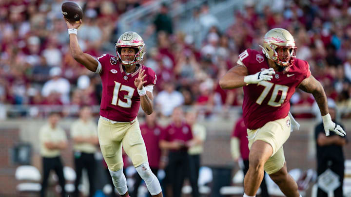 Florida State Seminoles quarterback Jordan Travis (13) passes to his teammate. The Florida State