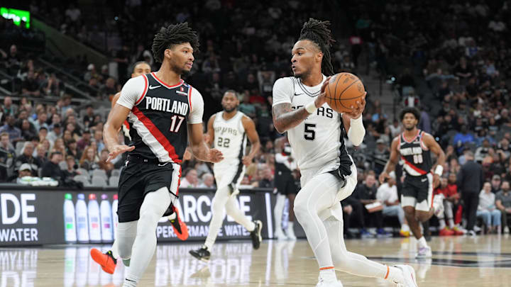 Nov 7, 2024; San Antonio, Texas, USA;  San Antonio Spurs guard Stephon Castle (5) drives against Portland Trail Blazers guard Shaedon Sharpe (17) in the first half at Frost Bank Center. 