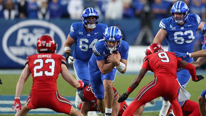 Oct 18, 2025; Provo, Utah, USA; BYU Cougars quarterback Bear Bachmeier (middle) runs against Utah Utes safety Jackson Bennee (23) and cornerback Elijah Davis (9) during the first quarter at LaVell Edwards Stadium. Credit: Rob Gray-Imagn Images