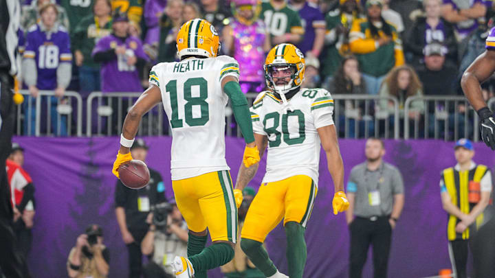Dec 29, 2024; Minneapolis, Minnesota, USA; Green Bay Packers wide receiver Malik Heath (18) celebrates his touchdown with wide receiver Bo Melton (80) against Minnesota Vikings in the fourth quarter at U.S. Bank Stadium. Mandatory Credit: Brad Rempel-Imagn Images