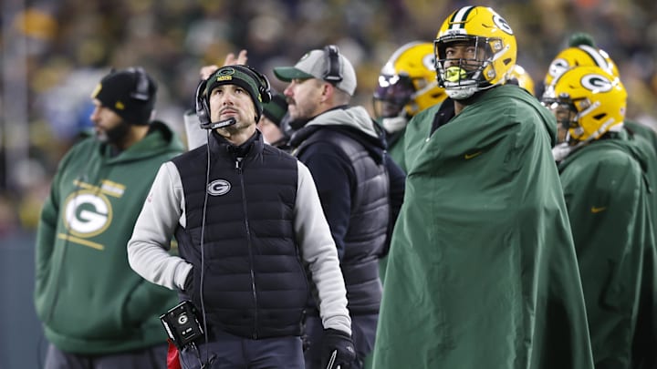 Jan 22, 2022; Green Bay, Wisconsin, USA; Green Bay Packers head coach Matt LaFleur (center) looks on from the sidelines in the first half against the San Francisco 49ers during a NFC Divisional playoff football game at Lambeau Field. Mandatory Credit: Jeff Hanisch-Imagn Images