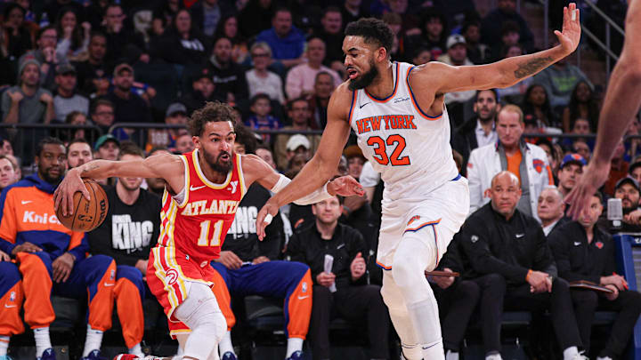 Jan 20, 2025; New York, New York, USA; Atlanta Hawks guard Trae Young (11) is guarded by New York Knicks center Karl-Anthony Towns (32) during the second half at Madison Square Garden. Mandatory Credit: Vincent Carchietta-Imagn Images