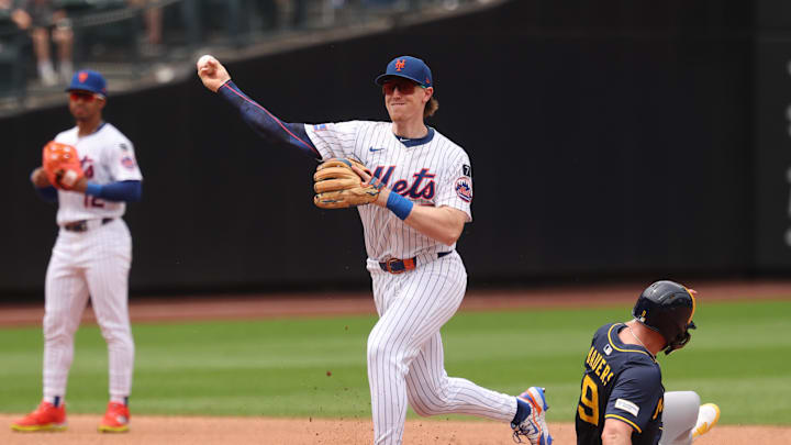 Jul 2, 2025; New York City, New York, USA;  New York Mets second baseman Brett Baty (7) forces out Milwaukee Brewers outfielder Jake Bauers (9) at second base and throws to first to complete the double play on a ball hit by shortstop Joey Ortiz (not pictured) during the fourth inning at Citi Field. Mandatory Credit: Vincent Carchietta-Imagn Images