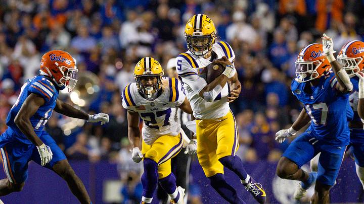 Nov 11, 2023; Baton Rouge, Louisiana, USA; LSU Tigers quarterback Jayden Daniels (5) rushes against the Florida Gators during the second half at Tiger Stadium. Mandatory Credit: Stephen Lew-USA TODAY Sports Nov 11, 2023; Baton Rouge, Louisiana, USA; LSU Tigers quarterback Jayden Daniels (5) rushes against the Florida Gators during the second half at Tiger Stadium. Mandatory Credit: Stephen Lew-USA TODAY Sports