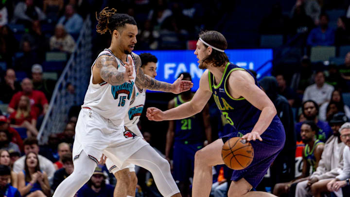 Mar 9, 2025; New Orleans, Louisiana, USA;  New Orleans Pelicans forward Kelly Olynyk (13) dribbles against Memphis Grizzlies forward Brandon Clarke (15) during the second half at Smoothie King Center. Mandatory Credit: Stephen Lew-Imagn Images